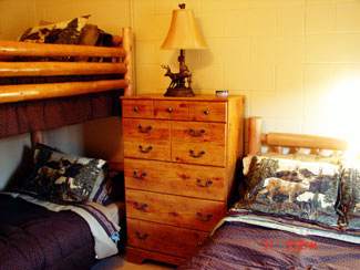 Bedroom with bunk beds and single bed -  Langham Outdoors Lodge building
